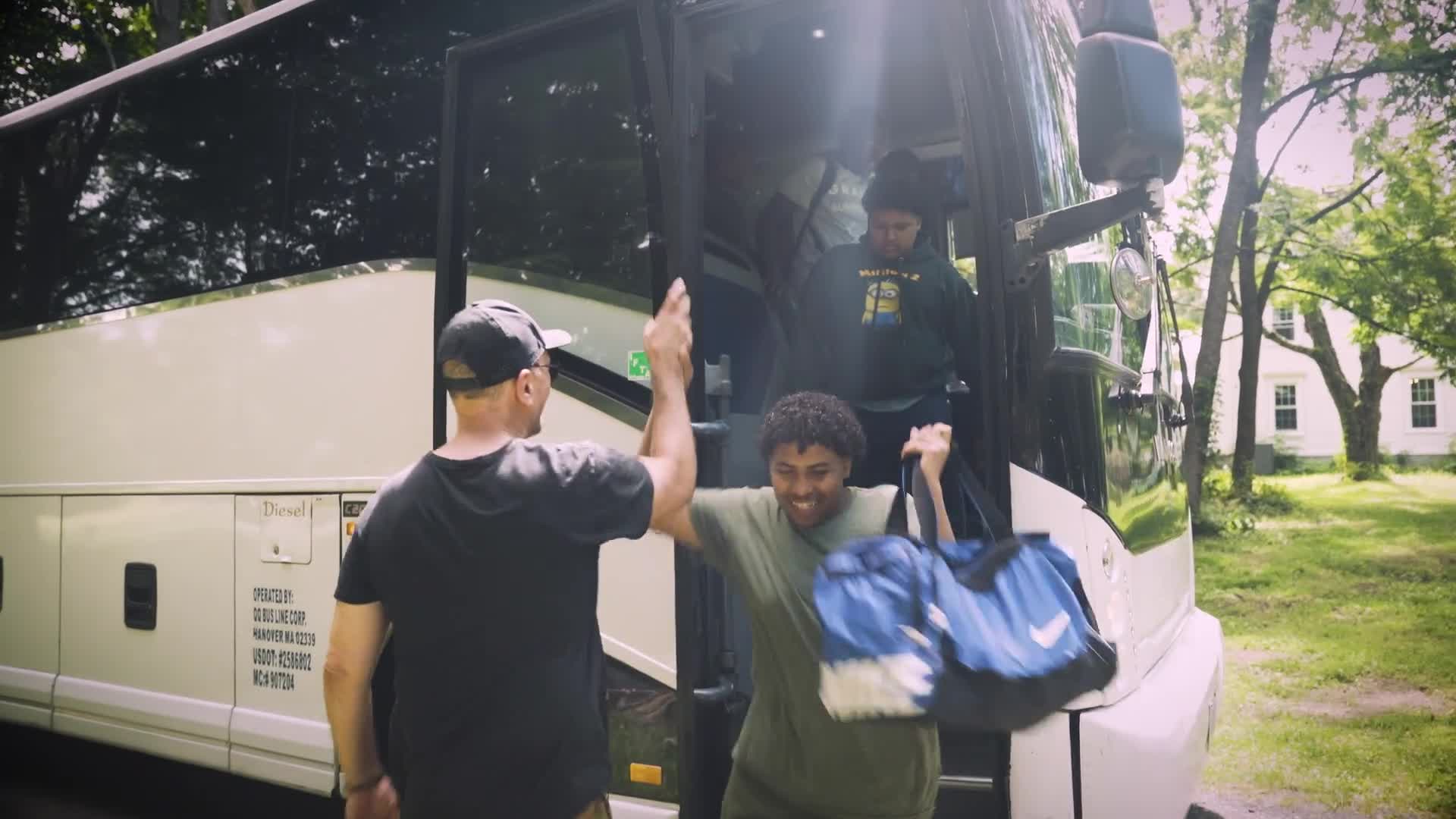 Brave Camp Year 2 — campers greeting each other outside the bus